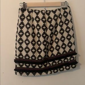 Pattern skirt with fringe. Black, white, and pink.